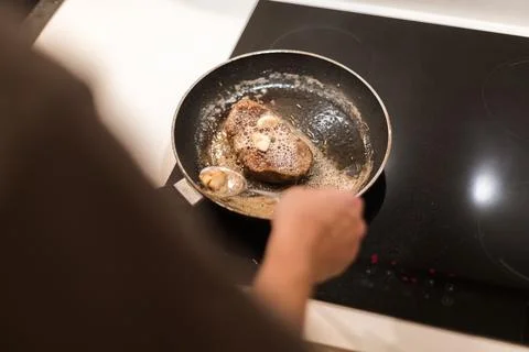 The process of cooking beef steak in a frying pan Stock Photos