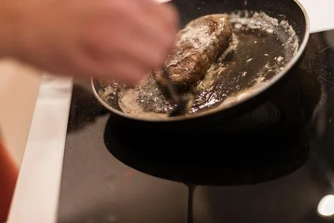 The process of cooking beef steak in a frying pan Stock Photos