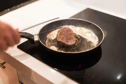 The process of cooking beef steak in a frying pan Stock Photos