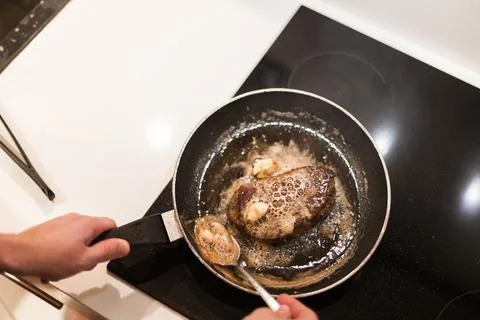 The process of cooking beef steak in a frying pan Stock-Fotos