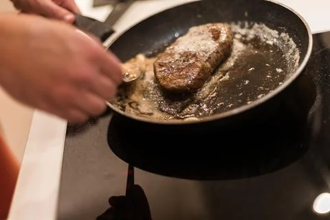 The process of cooking beef steak in a frying pan Stock Photos
