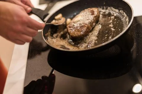 The process of cooking beef steak in a frying pan Stock Photos