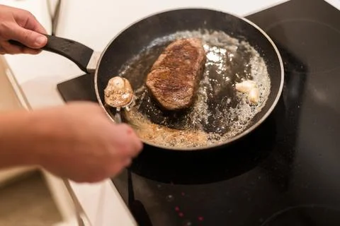The process of cooking beef steak in a frying pan Stock-Fotos