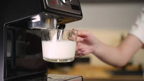 The process of cooking, brewing Americano. Close-up of women's hands brewing Stock-Footage 235920883