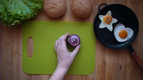The process of cooking a burger directly above a wooden table. Stock Footage 104724293