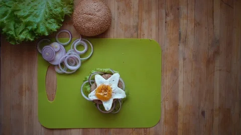 The process of cooking a burger directly above the wooden table . Stock Footage 106375921