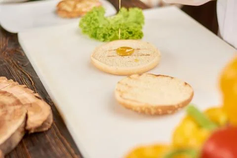 The process of cooking burger at kitchen. Stock Photos