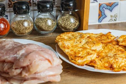 The process of cooking chicken chops with already fried chops in the backgrou Stock Photos
