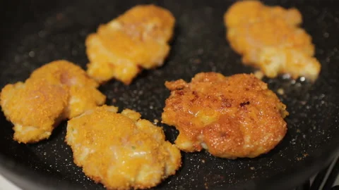 The process of cooking chicken cutlets in a pan, close up Stock Footage 167296011
