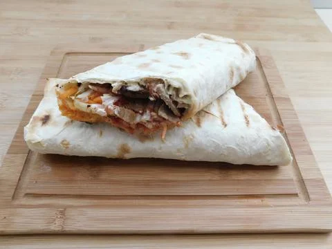 The process of cooking chicken wrap on kitchen table at home concept. Homemad Stock Photos