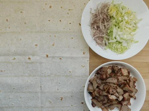 The process of cooking chicken wrap on kitchen table at home concept. Homemad Foto stock