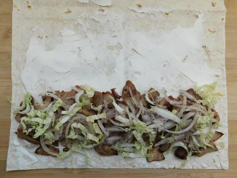 The process of cooking chicken wrap on kitchen table at home concept. Homemad Stock Photos