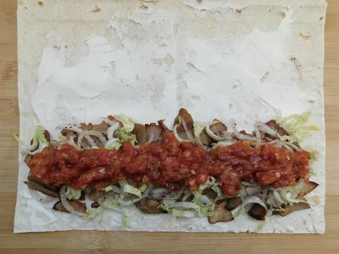 The process of cooking chicken wrap on kitchen table at home concept. Homemad Foto stock