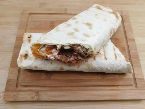The process of cooking chicken wrap on kitchen table at home concept. Homemad Foto stock
