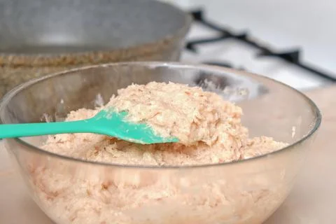 The process of cooking chopped chicken cutlets. Meat puree in a transparent Stock Photos