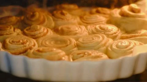 The process of cooking cinnamon rolls in the oven in the home kitchen Stock Photos