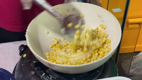 The process of cooking corn cheese with melting mozzarella in a hot pan. Stock Footage 320475861