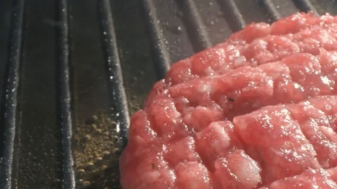 The process of cooking cutlet for a burger. The chef cooks a burger in the Stock Footage 115778773