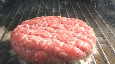 The process of cooking cutlet for a burger. The chef cooks a burger in the Stock Footage 115779274