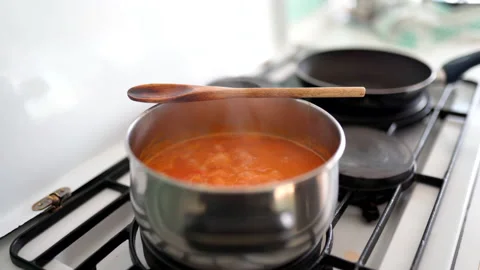 Process of cooking delicious spicy tomato sauce in metal pan with vegetables Stock Footage 145684337