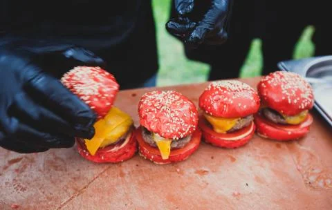 Process of cooking different multi colored burgers on open-air festival, view Foto stock