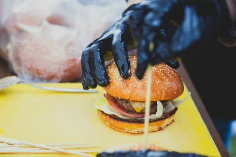 Process of cooking different multi colored burgers on open-air festival, view 스톡 사진