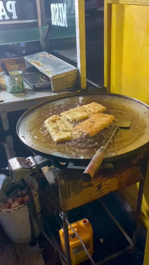 The process of cooking egg martabak on a frying pan Stock Footage 276901739