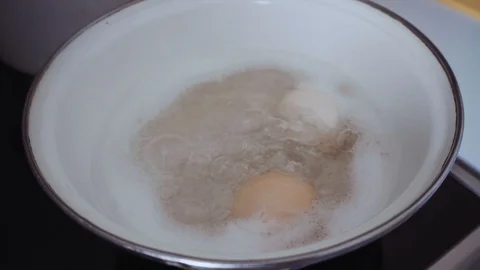 The process of cooking eggs in boiling water Stock Footage 112043693