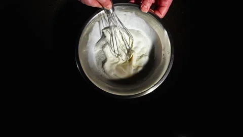 The process of cooking with eggs. The cook whips the batter with a whisk. Egg Stock Footage 264392442