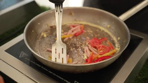 The process of cooking food in a hot pan from different ingredients Stock Footage 313668523