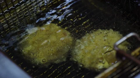 Process of cooking fried cheese snack in boiling oil Stock Footage 266931778