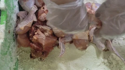 The process of cooking fried chicken with flour, crispy fried chicken. Stock Footage 233478625