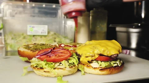 The process of cooking a hamburger. Male hands in gloves. Stock Footage 208380971