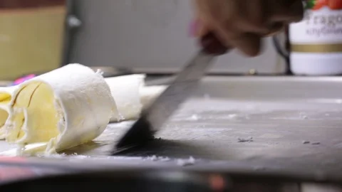 The process of cooking an ice cream roll in a freezer. Stock Footage 89442120