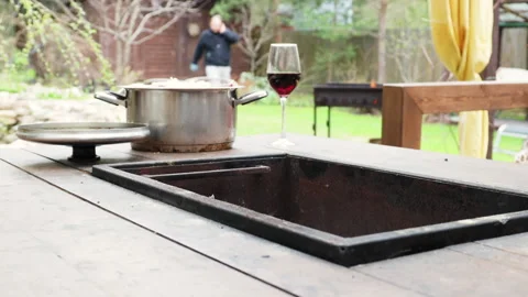 The process of cooking kebab on a table with a built-in barbecue, dinner outdoor Stock Footage 274175947