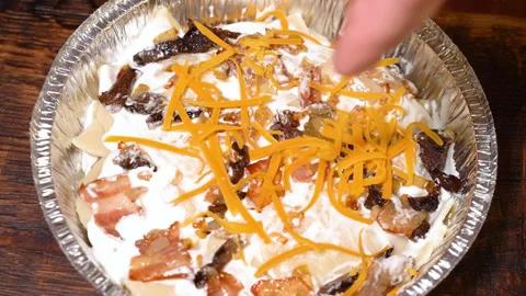 The process of cooking lasagna in an alumen form, sprinkled with carrots Stock Footage 248983736