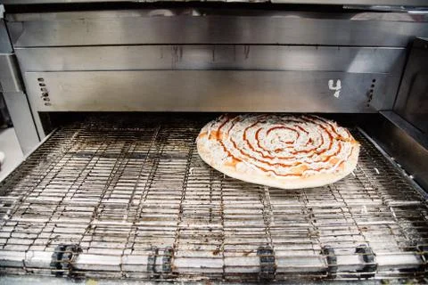 Process of cooking, making, baking pizza on grill. Close up. Restaurant, cafe Stock Photos