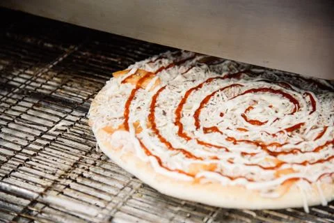 Process of cooking, making, baking pizza on grill. Close up. Restaurant, cafe Stock Photos