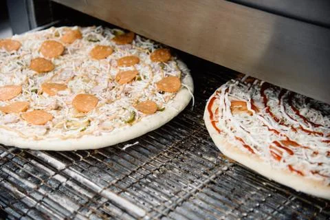 Process of cooking, making, baking pizza on grill. Close up. Restaurant, cafe Stock Photos