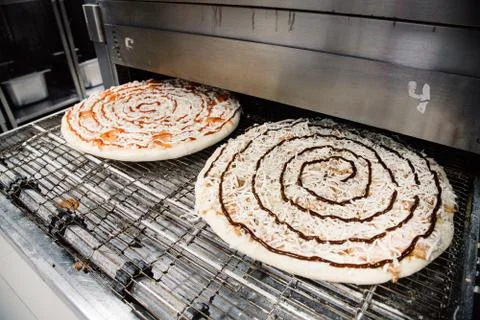 Process of cooking, making, baking pizza on grill. Close up. Restaurant, cafe Stock Photos