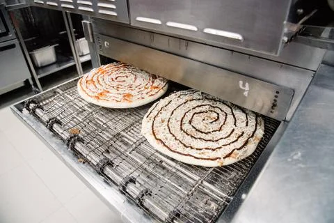 Process of cooking, making, baking pizza on grill. Close up. Restaurant, cafe Stock Photos