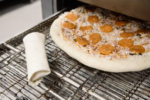 Process of cooking, making, baking pizza on grill. Close up. Restaurant, cafe Stock Photos