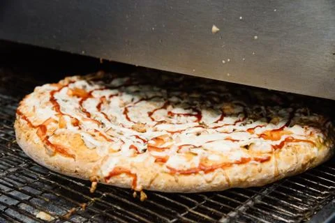 Process of cooking, making, baking pizza on grill. Close up. Restaurant, cafe Stock Photos