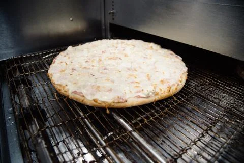 Process of cooking, making, baking pizza on grill. Close up. Restaurant, cafe Stock Photos