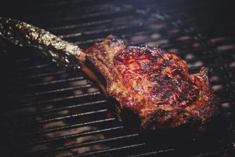 Process of cooking meat on the grill close-up. Stock Photos