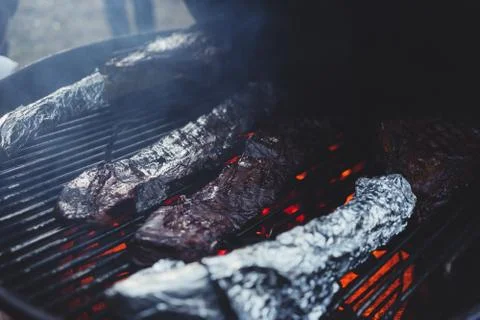 Process of cooking meat on the grill close-up. Stock Photos