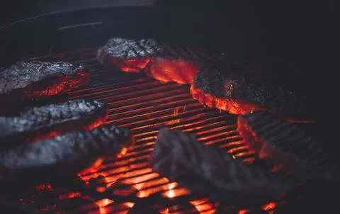 Process of cooking meat on the grill close-up. Stock Photos
