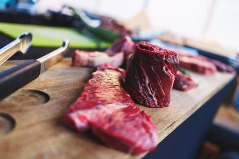 Process of cooking meat on the grill close-up. Stock Photos