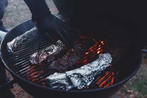 Process of cooking meat on the grill close-up. Stock Photos