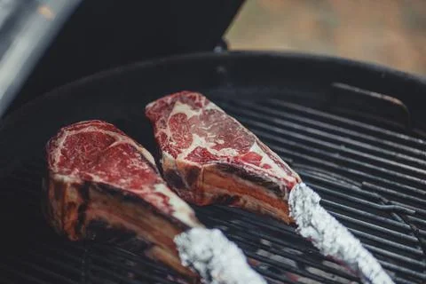 Process of cooking meat on the grill close-up. Stock Photos